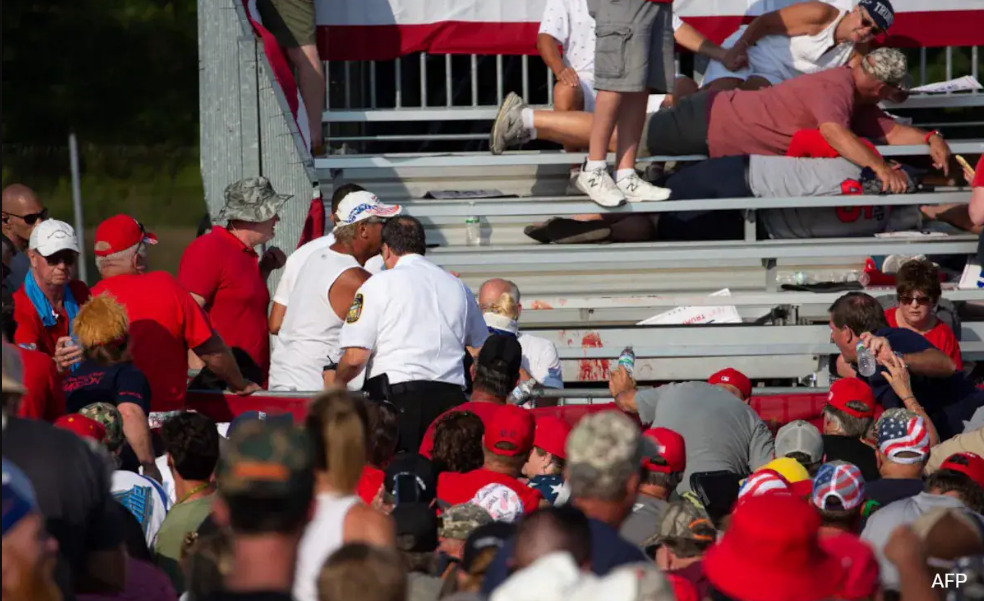 Two people, including the suspected shooter, were found dead at a Trump rally, with blood visible on the former president’s ear.