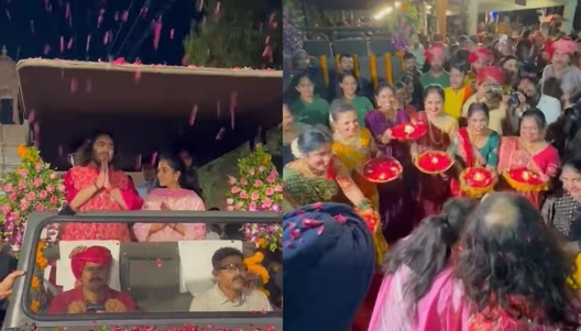 Anant Ambani and Radhika Merchant greet with folded hands while being welcomed with a shower of flower petals and aarti in Jamnagar. Observe