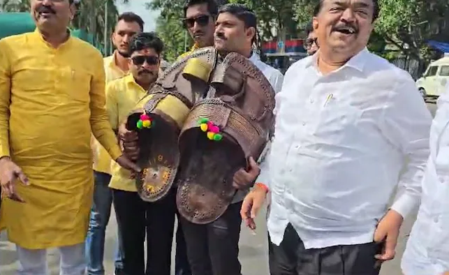 Protesters in Mumbai, India, express anger by hitting with footwear after Shivaji statue collapse